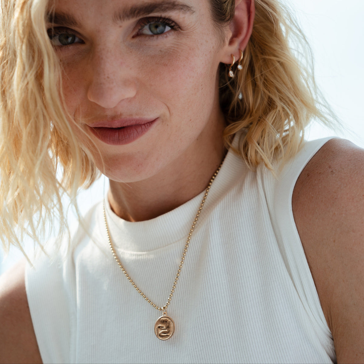 A vintage Aquarius charm featuring the Water Bearer pouring water on the front and a beautifully detailed spiral motif on the reverse. Rich in character and craftsmanship, this classic zodiac piece offers an easy, wearable feel whether styled on its own or layered into a charm collection. A timeless keepsake for those born under Aquarius or anyone drawn to its symbolism.