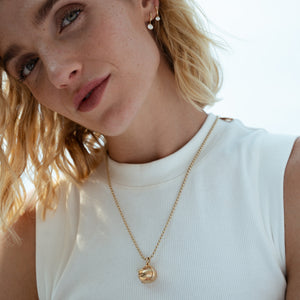 A true showstopper and a remarkable example of vintage craftsmanship. This orb charm opens to reveal an ingenious folding locket with space for four treasured photographs, transforming a classic pendant into a deeply personal keepsake.
