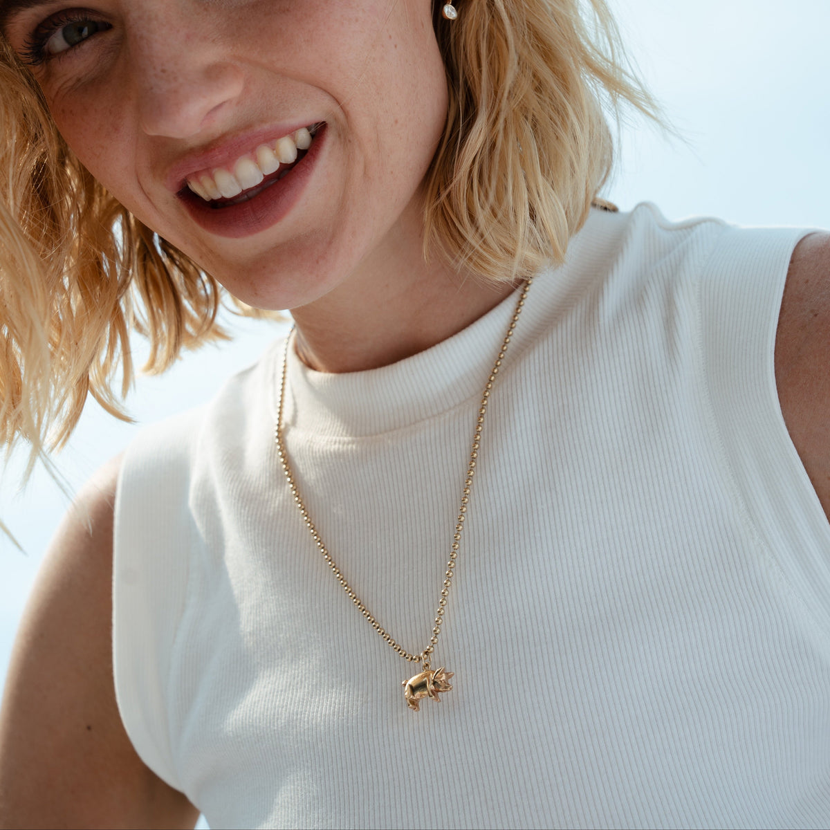 A solid gold vintage pig charm