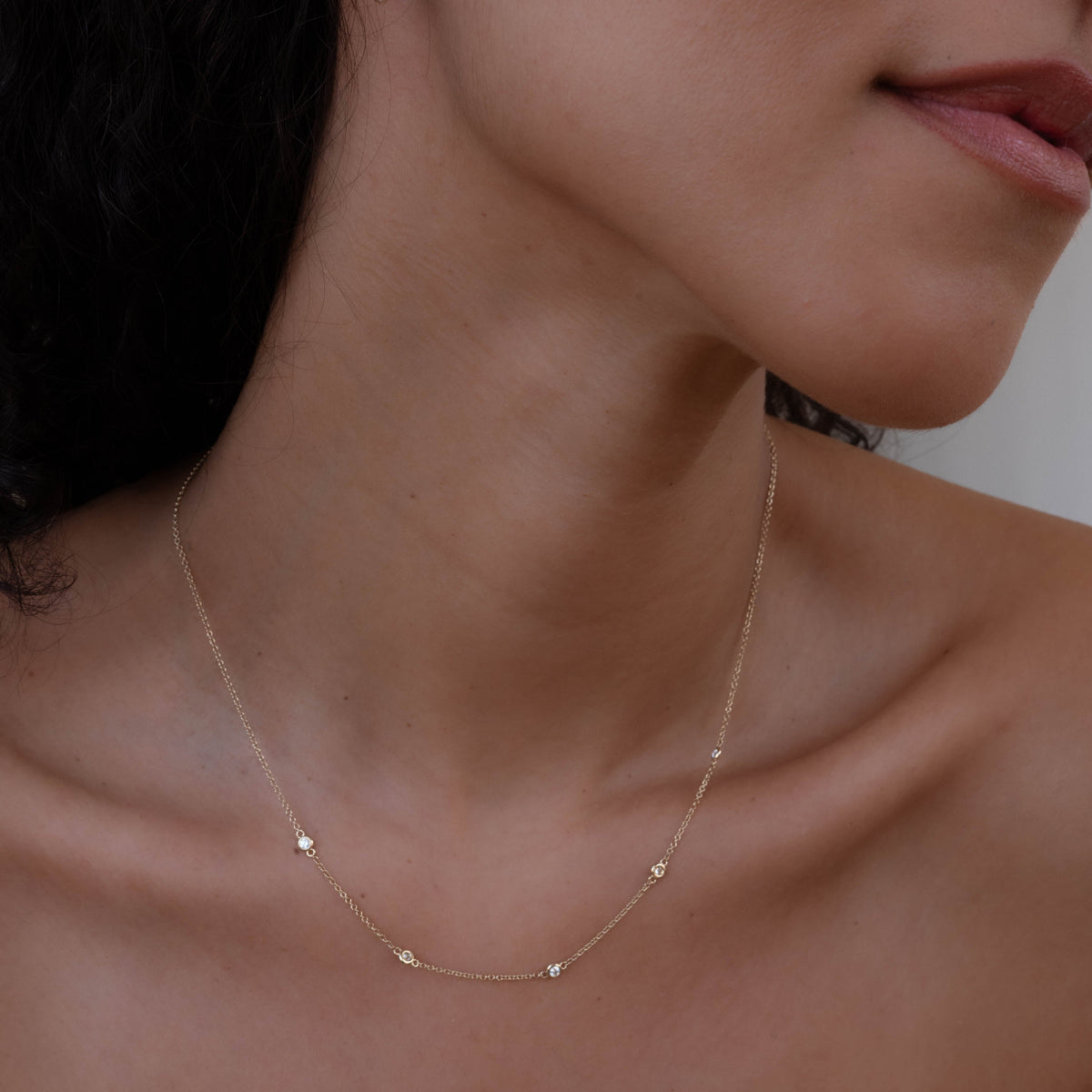 14k solid gold In Line Diamond Necklace with diamonds spaced along the chain
