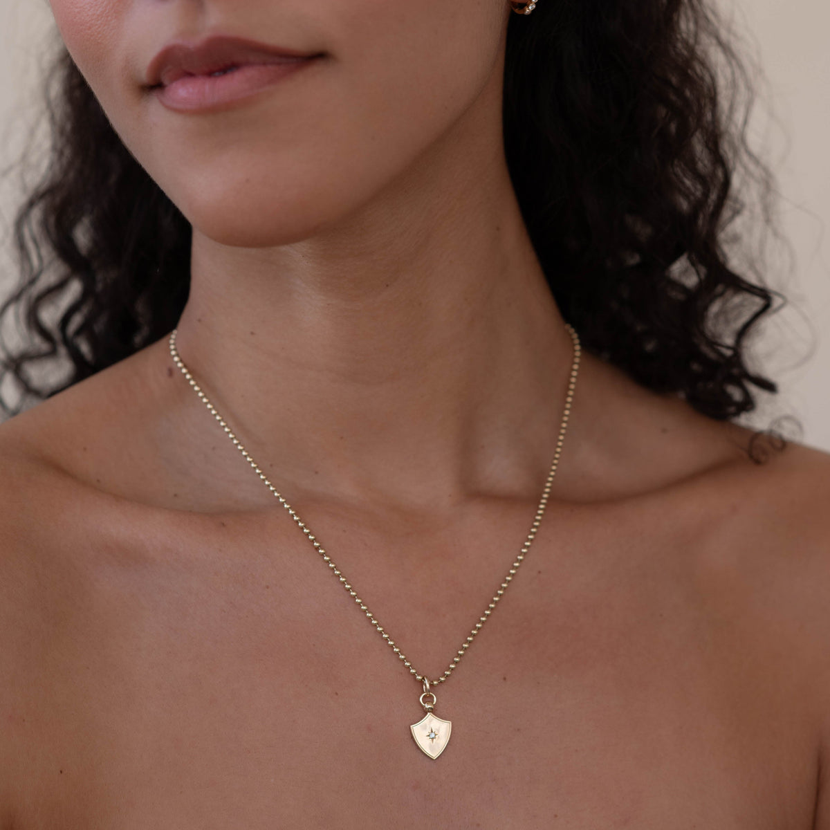 14k solid gold Star Set Shield Charm with star-set diamonds