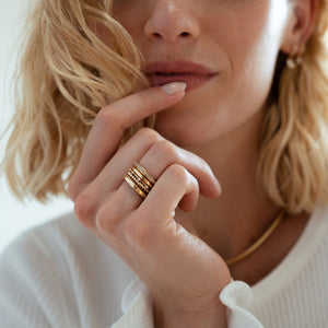 Solid gold rings with a soft trapezoidal shape stacked