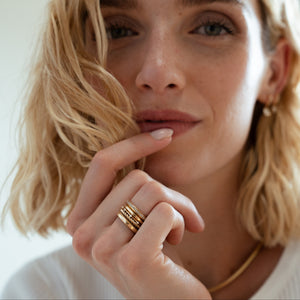 Fewer Finer Signature Band and eternity stack of solid gold rings