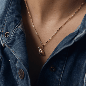 Model wearing 14k gold alternating link style chain necklace with Golden Doodle Dog Charm