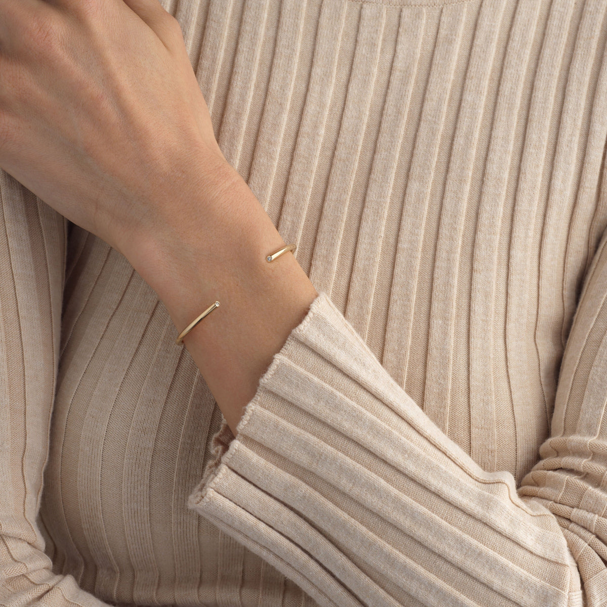 A close-up of the solid gold diamond cuff with two diamonds accented on either end