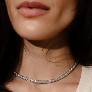 close-up of a vintage platinum diamond tennis necklace with hand engraving details