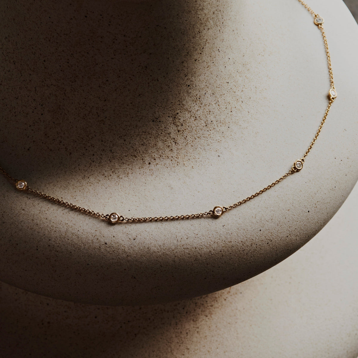 14k solid gold In Line Diamond Necklace with diamonds spaced along the chain