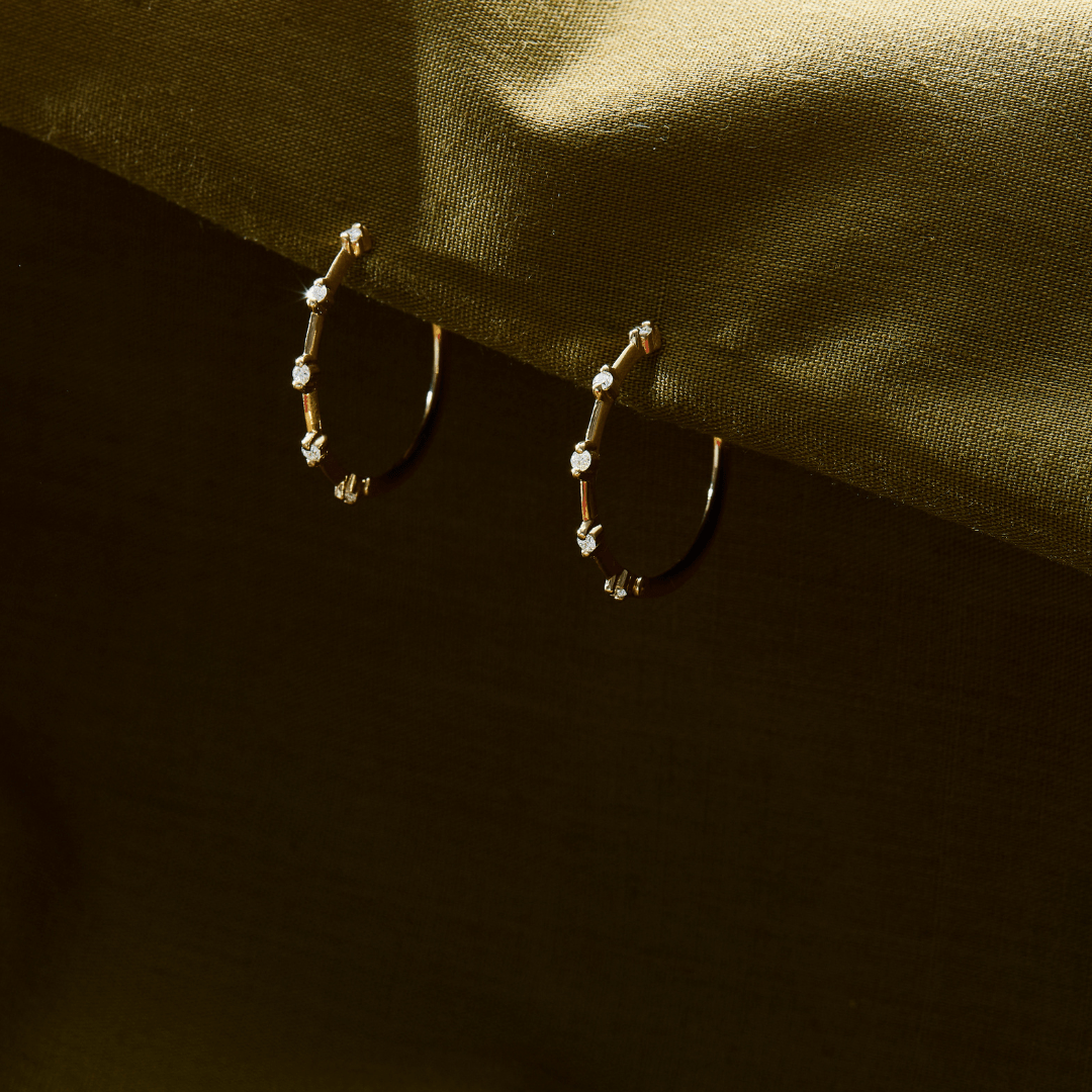 14k solid gold String Lights Hoops with diamonds spaced along the band