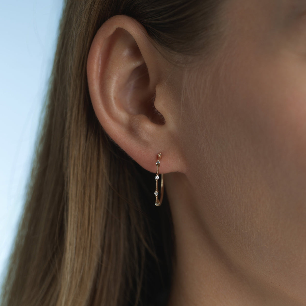 14k solid gold String Lights Hoops with diamonds spaced along the band