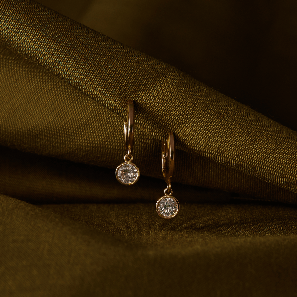 14k solid yellow gold Diamond Cutie Huggies with bezel-set drop diamonds