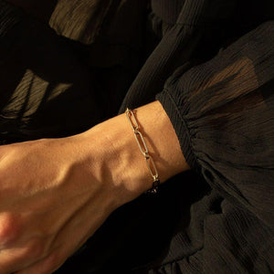 Model wearing the 14k semi-hollow gold link chain charm bracelet
