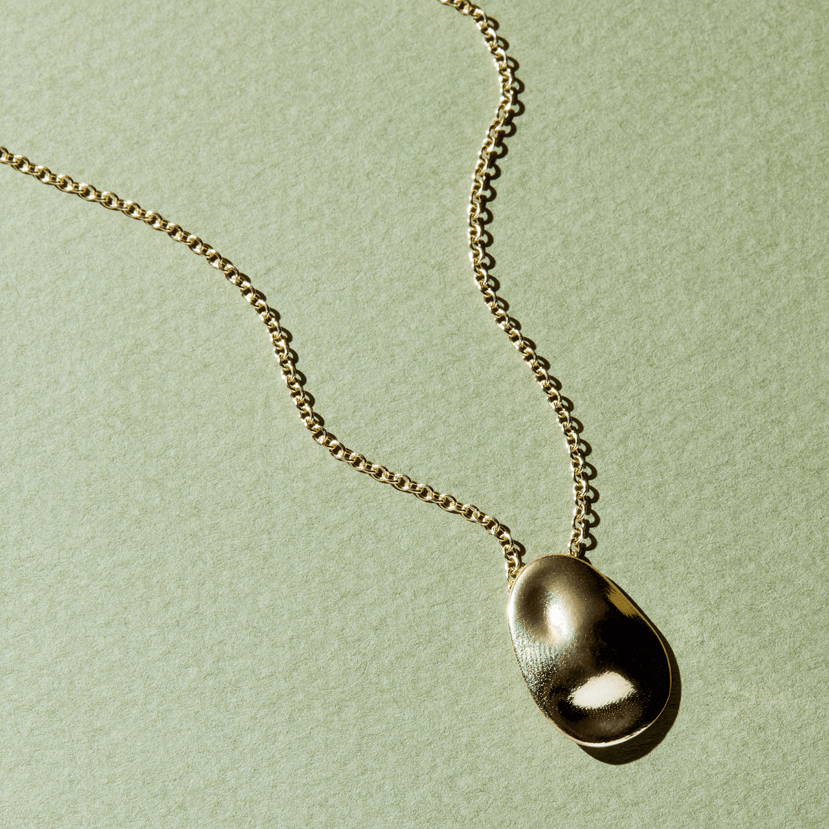 14k solid gold Worry Stone Necklace with a textured worry-stone pendant