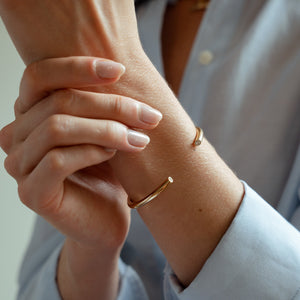 A close-up of the 4mm diamond cuff bracelet crafted in solid gold and two natural diamonds on either end