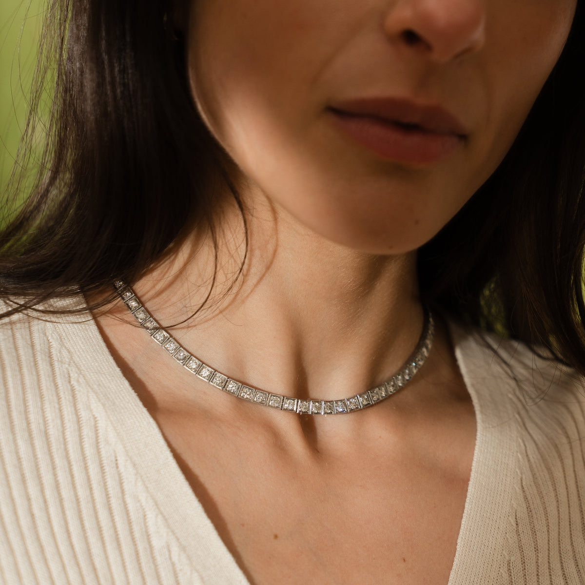 close-up of a vintage platinum diamond tennis necklace with hand engraving details