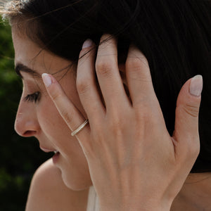 A triple pave diamond eternity band on hand in solid 14k yellow gold 