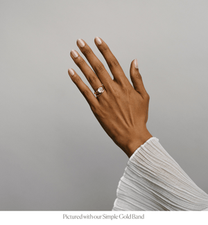 Model wearing the 14k solid gold chunky gypset style bezel set engagement ring stacked with the Simple Gold Band