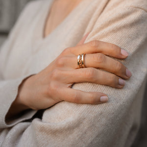 Model wearing rounded 14k gold band with a petite baguette diamond stacked with Signature Band and Thick Chain Ring