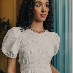 Model wearing layered lapis and turquoise beaded necklaces