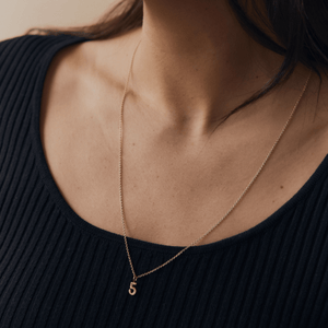 Model wearing the 14k gold cable chain necklace with the '5' Simple Number Charm