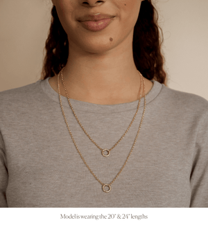 Model wearing two 14k gold charm collector rolo chain necklaces