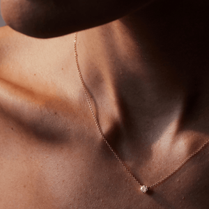 Model wearing 14k gold solitaire diamond necklace