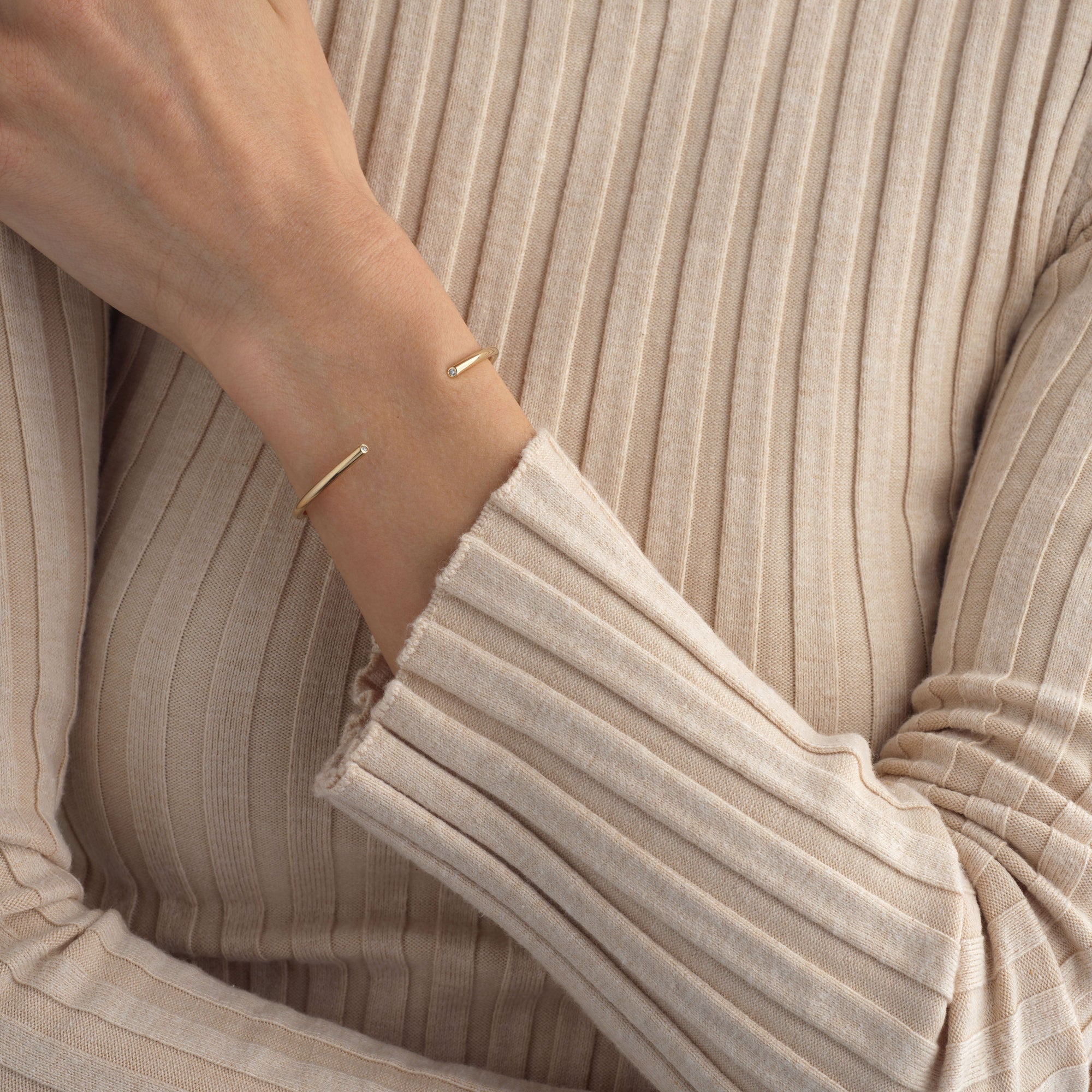 14k gold rounded cuff bracelet with diamonds at each end