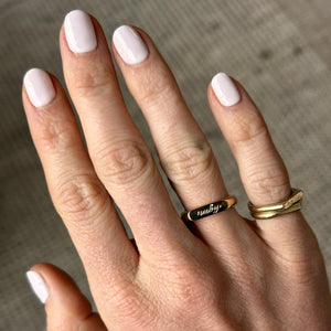 Model wearing 14k solid gold double sided straight signet ring with a hand engraved name