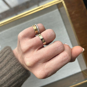 Model wearing the 14k gold ring with Ginkgo leaf imprints across the band on ring finger