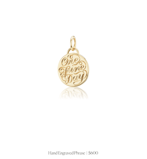 Hand engraved phrase in script on the 14k solid gold circle charm