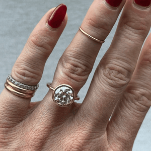 Model wearing the 14k gold open bezel solitaire engagement ring