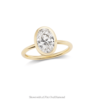 14k gold open bezel solitaire engagement ring with an oval diamond