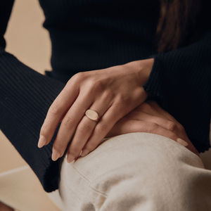 Model wearing 14k solid gold engravable oval signet ring