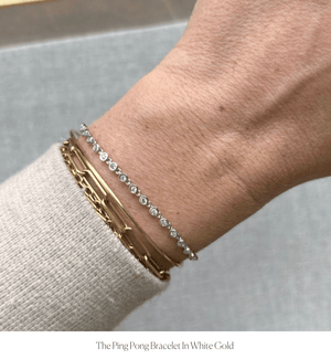 Model wearing 14k white gold tennis bracelet with bezel set diamond links