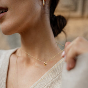 Model wearing 14k solid gold pebble necklace