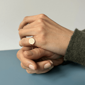 Model wearing 14k solid gold engraved round signet ring