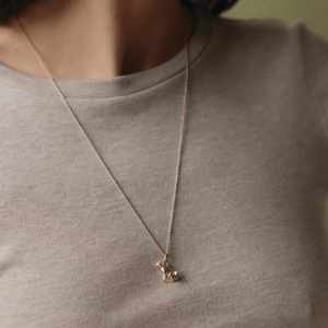 Model wearing 14k gold Shiba Inu dog charm on a cable chain