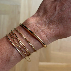 Model wearing 14k solid gold bangle 