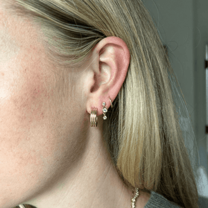 Model wearing 14k gold column-style hoops