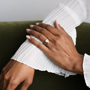 Model wearing the unisex 14k solid gold band engravable band stacked with the Arch Engagement Ring