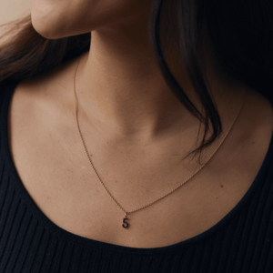 Model wearing 14k solid gold number 5 charm 