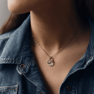 Model wearing 14k solid gold number 4 charm stacked with 2 engraved Classic Circle Charms on the Caviar Necklace