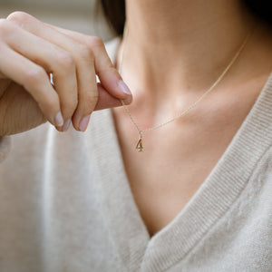 Model wearing 14k solid gold number 4 charm 