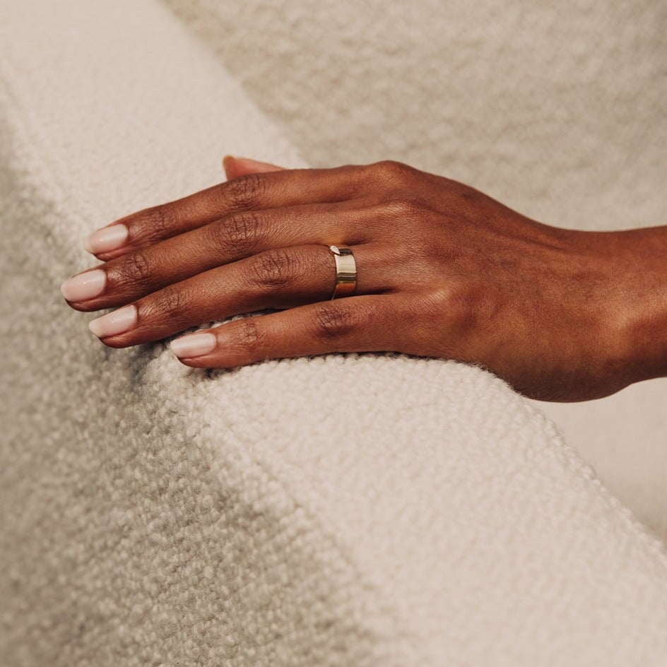 14k solid gold thick band ring with a bezel marquise diamond