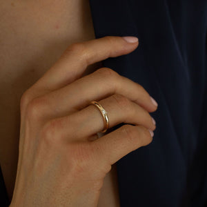 Model wearing 14k gold ring with petite baguette diamond