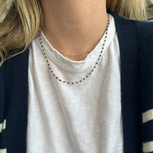 Model wearing 14k gold lapis beaded necklace 