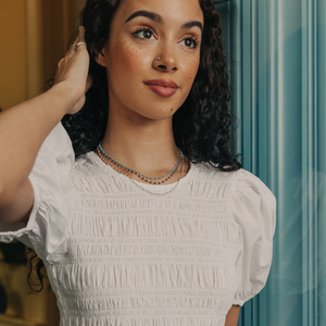 Model wearing 14k gold turquoise and lapis beaded necklace 