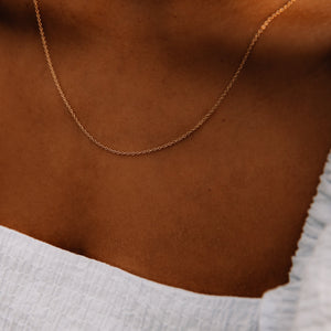 Model wearing 14k gold cable chain necklace 