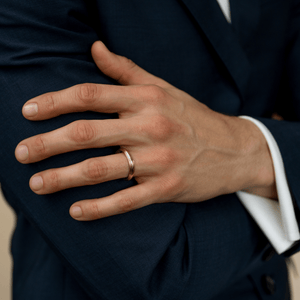 Male model wearing the unisex 14k solid gold column style wedding band