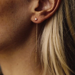 Model wearing 14k gold thread through diamond earrings with a petite dangly chain 