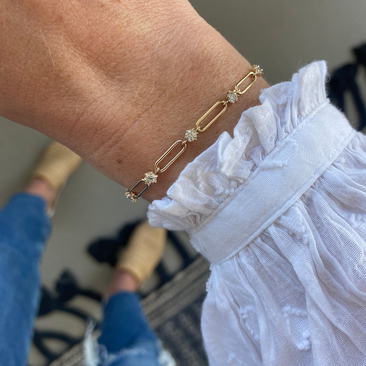 Model wearing a 14k gold link chain diamond bracelet